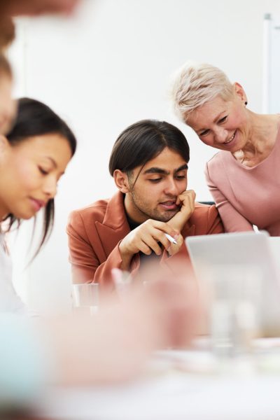 Portrait of contemporary business team collaborating on project in conference room, copy space